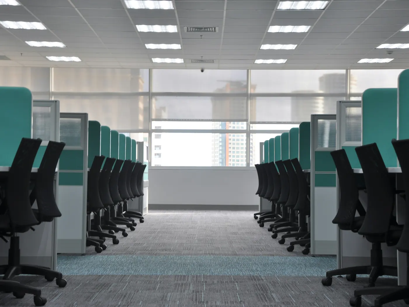 Clean open-plan office with tidy desks and chairs after commercial cleaning